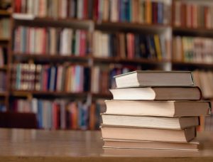 Close up of books on desk in library.